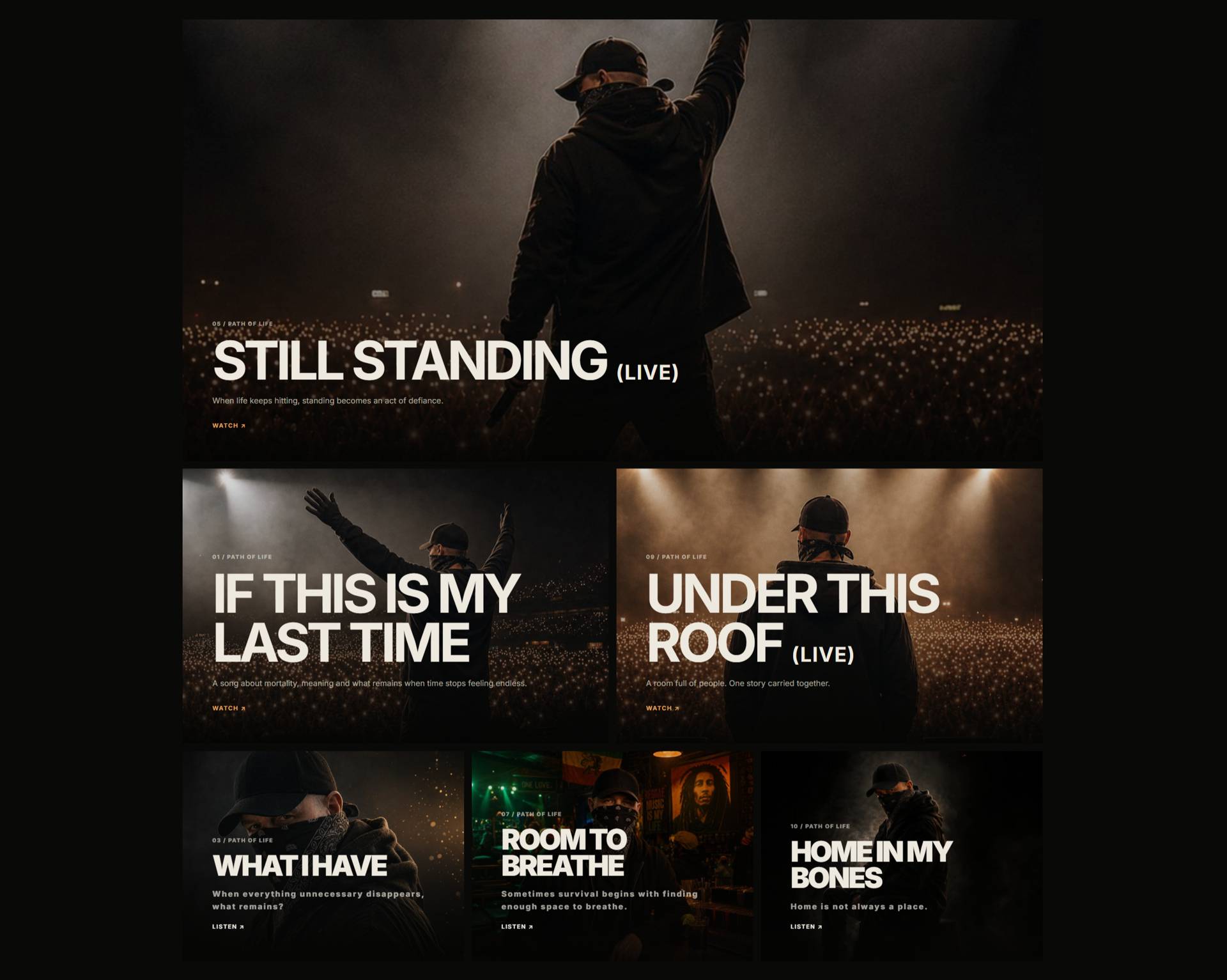 Performer on stage with back to audience, raising an arm during a live show; Still Standing (Live) poster banner.